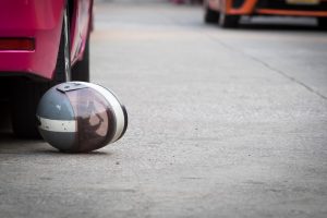 moped helmet lies on road near car