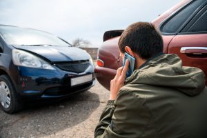 man on cell phone after auto wreck