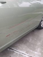 silver car with sideswipe damage
