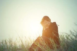 young-woman-crying-in-a-field