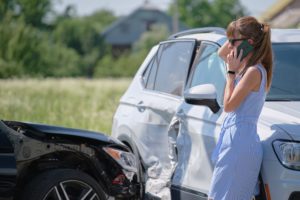 woman calling for help after fatal car accident