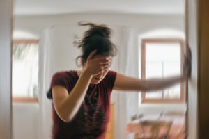 woman-with-seizure-holding-her-head