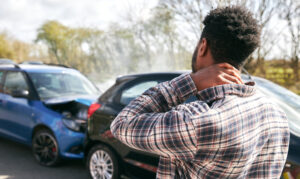 black man surveying crash damage