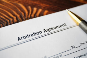 close-up of an arbitration agreement and a pen