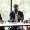 a male arbitrator discussing a car accident with three women and one man at a table.
