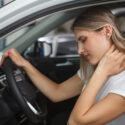 Woman in pain with whiplash after car accident in Atlanta.