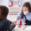 Victim of a truck accident negotiating more money for their claim with a lawyer